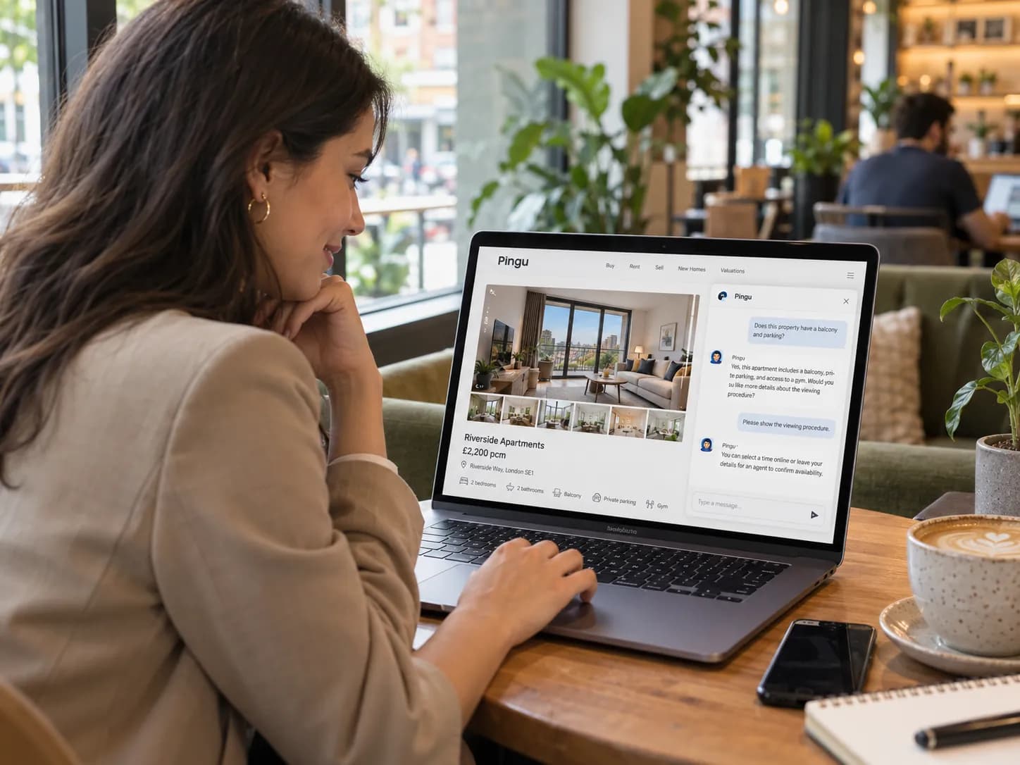 Property buyer on a laptop asking the Pingu chatbot about an apartment listing